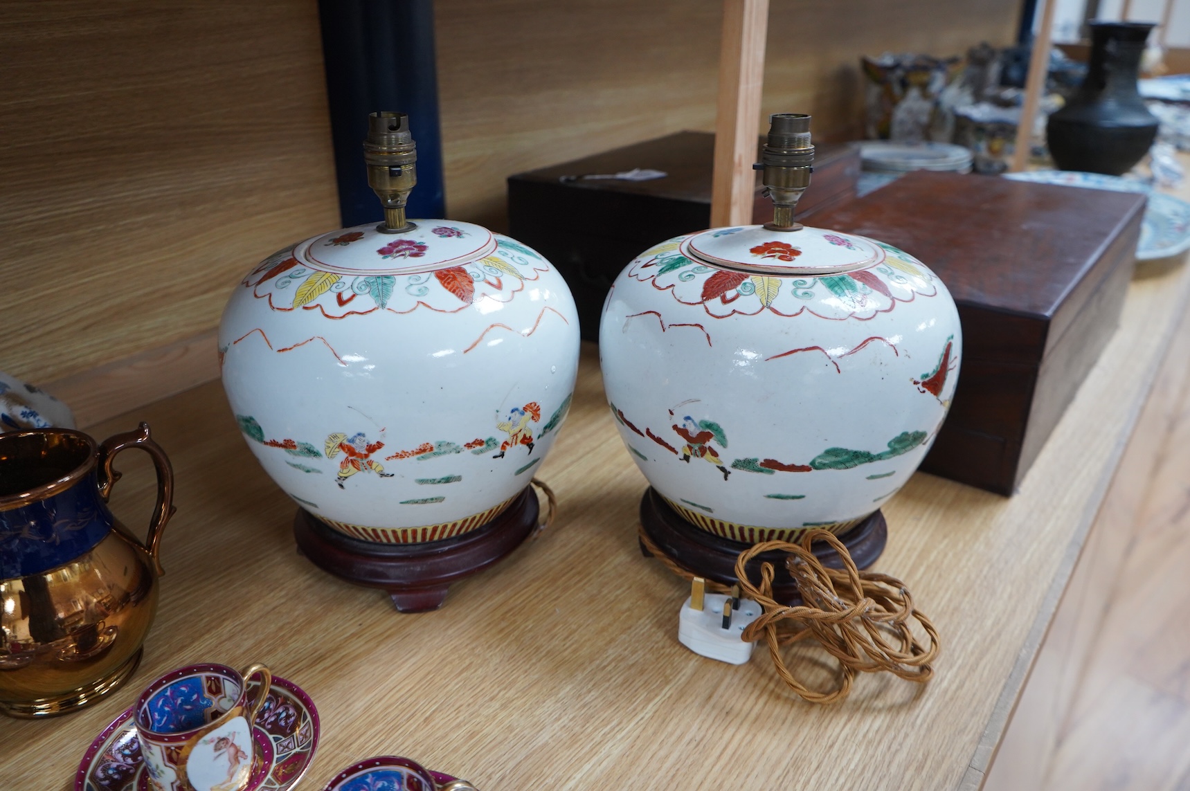 A pair of Chinese jar and covers on stands, converted later to lamps, 34cm including fittings.